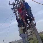 Video: Woman Wants To Live Together With Husband, Lover. Climbs Pole In Protest